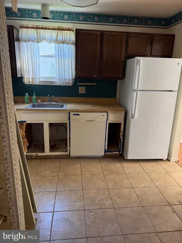 a kitchen with a stove a refrigerator and a cabinets