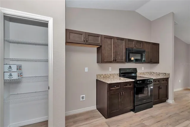 a kitchen with stainless steel appliances a sink and a microwave