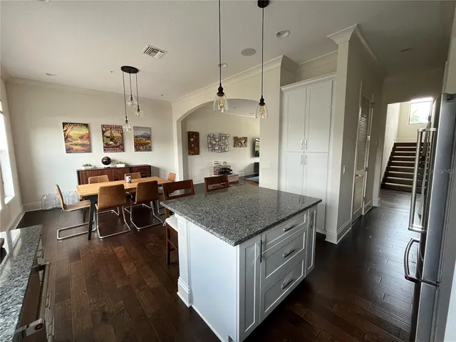 a kitchen with stainless steel appliances granite countertop a stove and a wooden floors