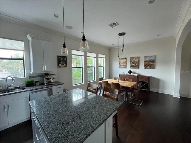 a kitchen with sink table and chairs