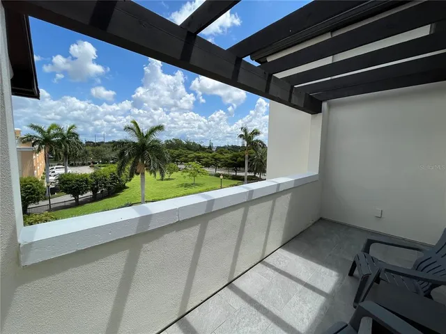 a living room with furniture and hard wood flooring