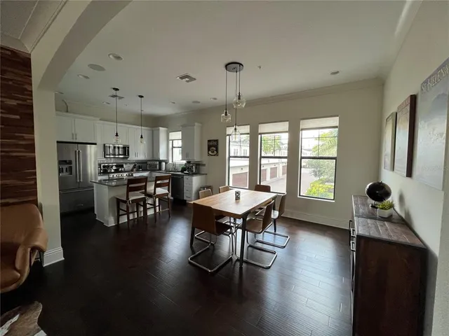 a dining room with furniture and wooden floor
