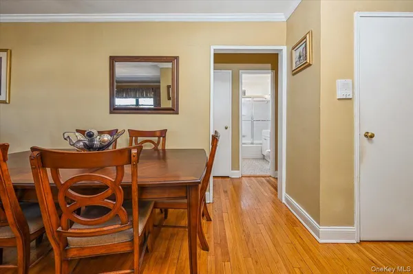 a dining room with furniture and wooden floor
