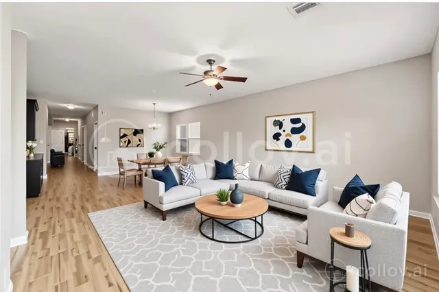 a living room with furniture a rug and a chandelier