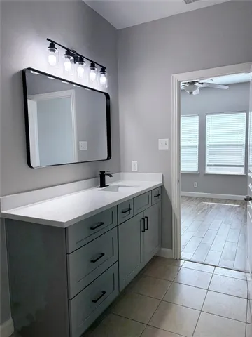 a bathroom with a double vanity sink mirror and