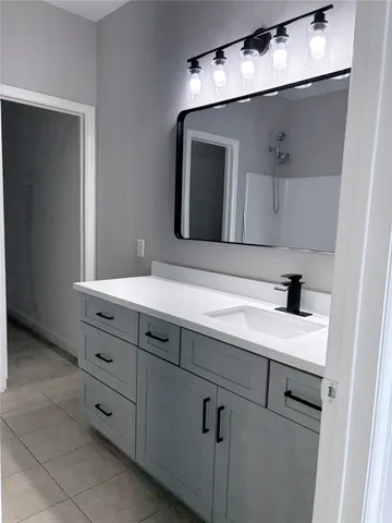 a bathroom with a sink and a mirror