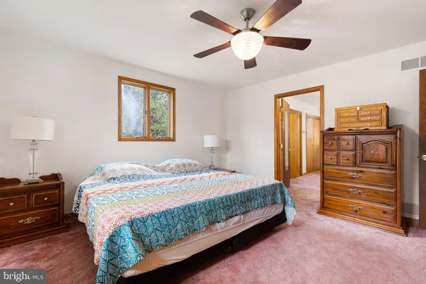 a bedroom with a bed and a tv