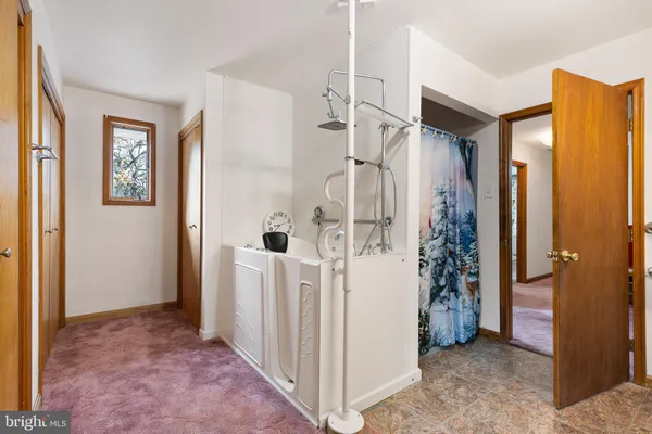 a view of entryway with bathroom and shower