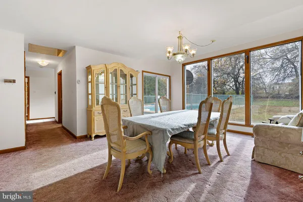 a view of a dining room with furniture large windows and wooden floor
