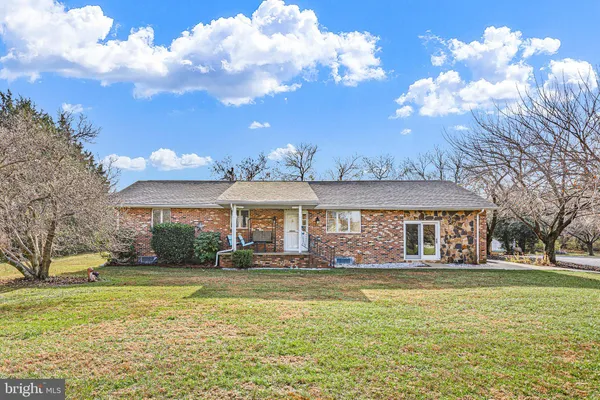 a front view of house with yard swimming pool and outdoor seating