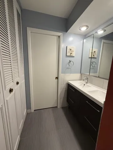 a view of a bathroom with a sink and mirror