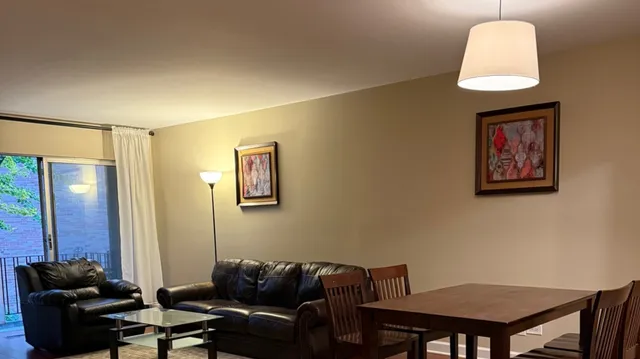 a living room with furniture and a mirror