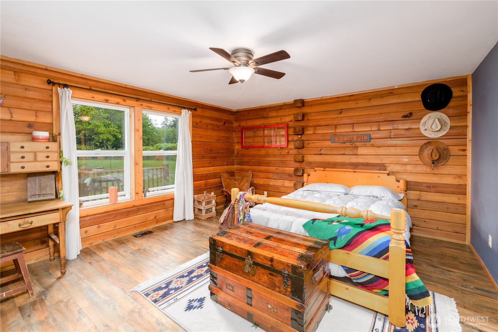 134 Bishop Road Port Angeles, WA 98363 - Photo 17 of 38 a bedroom with a bed and a chandelier