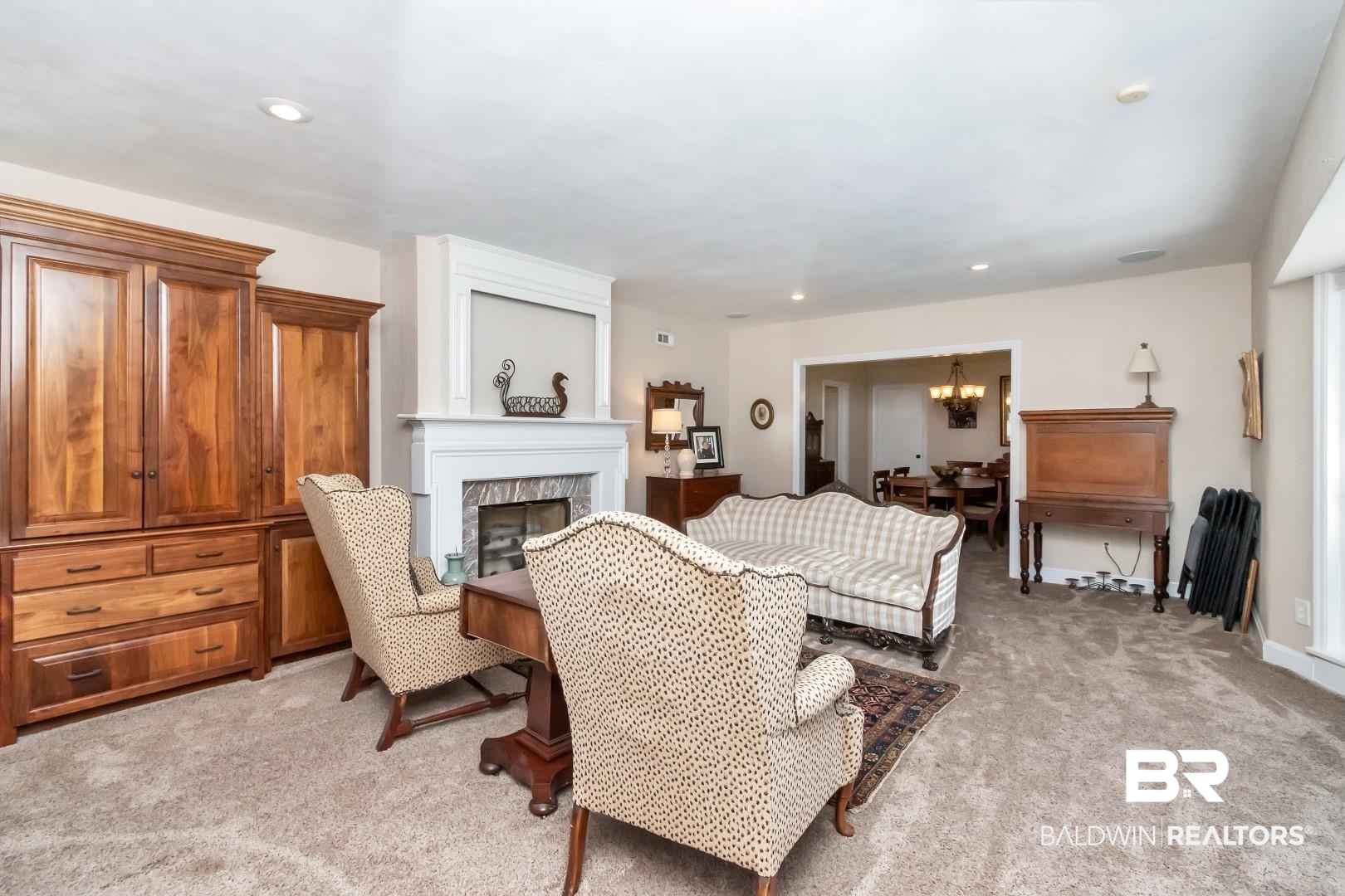 302 Springwood Drive East Mobile, AL 36608 - Photo 3 of 35 Living room featuring light carpet, a large fireplace, and a chandelier