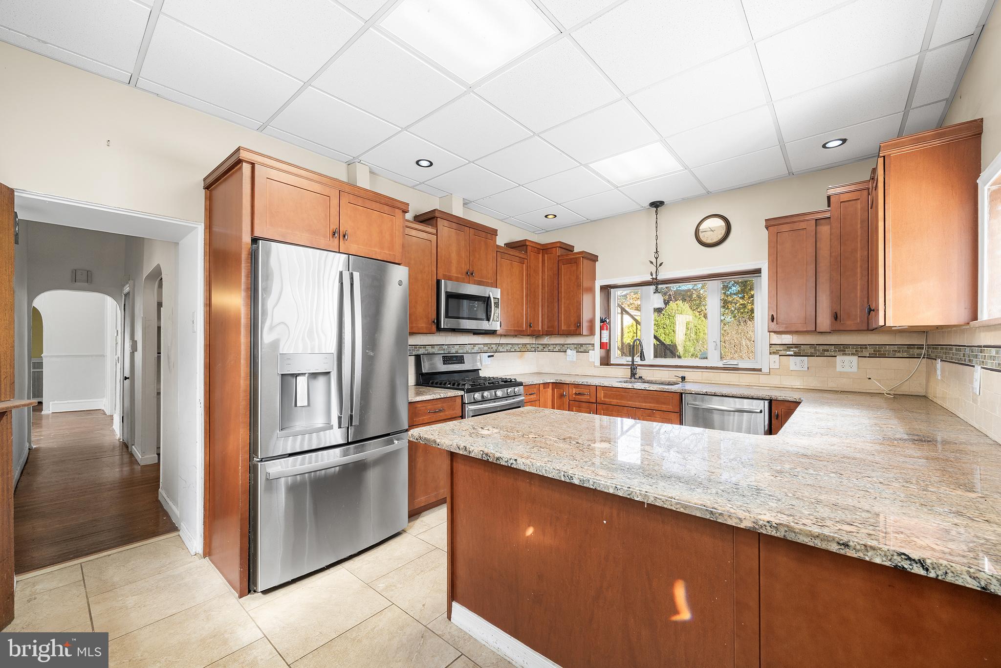 7301 Chestnut Avenue, Unit 1 Elkins Park, PA 19027 - Photo 1 of 22 a kitchen with stainless steel appliances granite countertop a refrigerator a sink and a stove