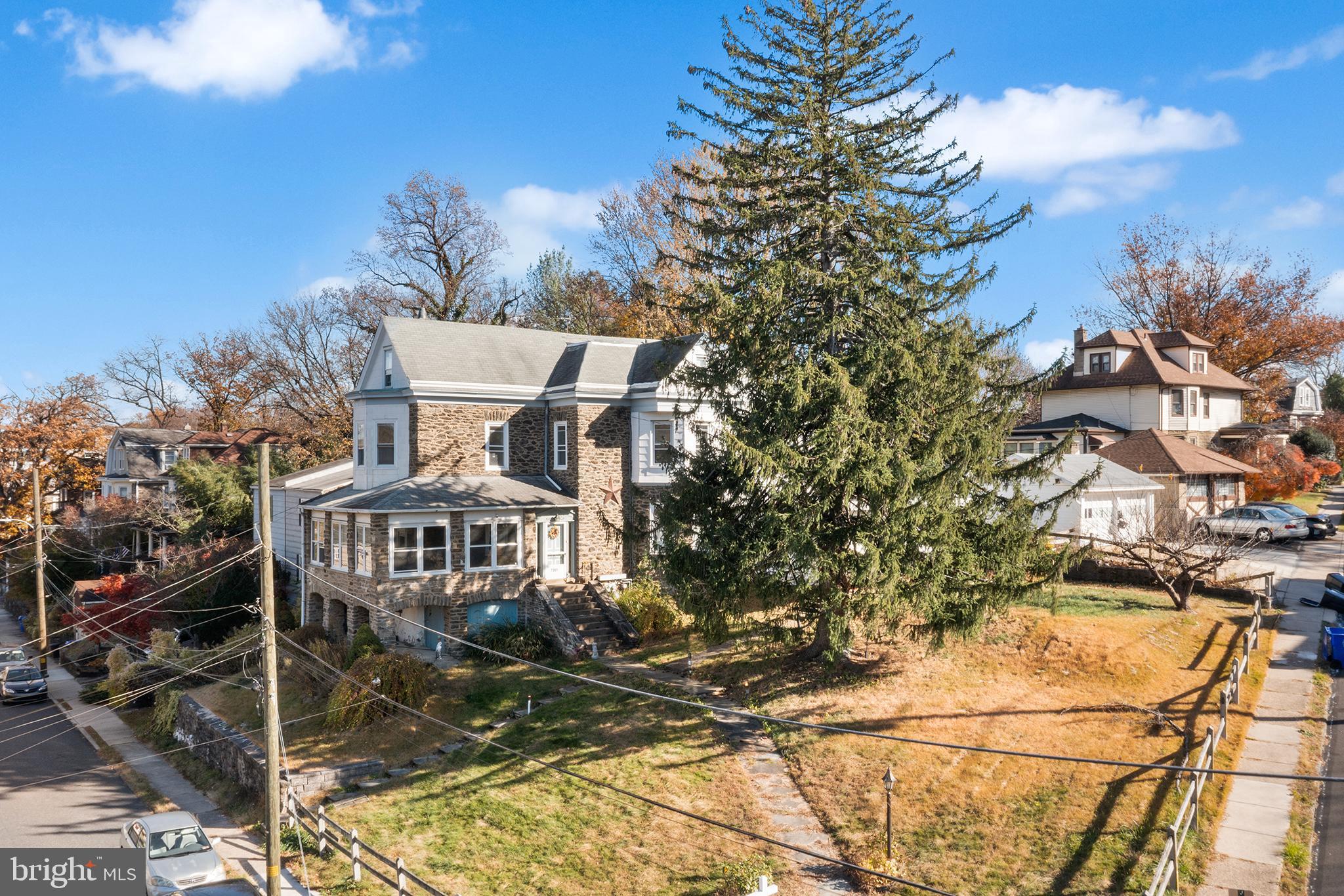 7301 Chestnut Avenue, Unit 1 Elkins Park, PA 19027 - Photo 21 of 22 a view of a tall building with a tree in the background
