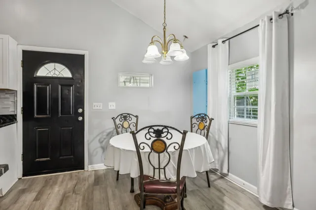 a view of a dining room with furniture and wooden floor