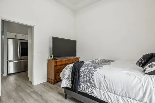 a bedroom with a bed and flat screen tv