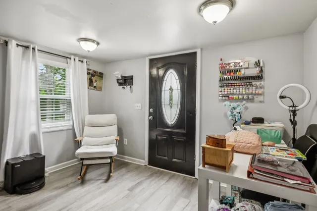 a living room with furniture a rug and a window