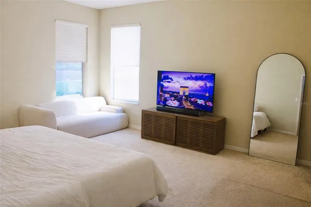 a bedroom with furniture and a flat screen tv