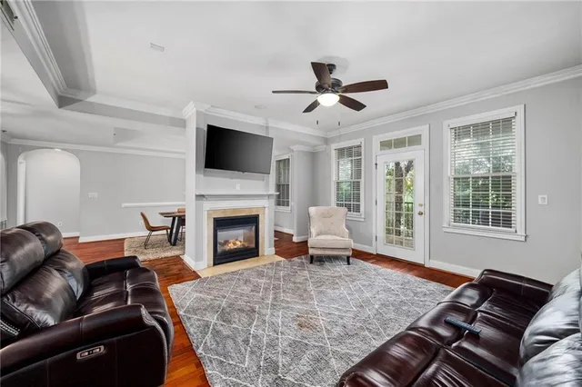 a living room with furniture a fireplace and a flat screen tv