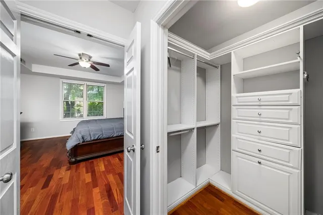 a view of walk in closet with clothes and shoes