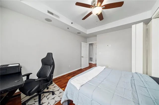 a bedroom with a bed and a chair