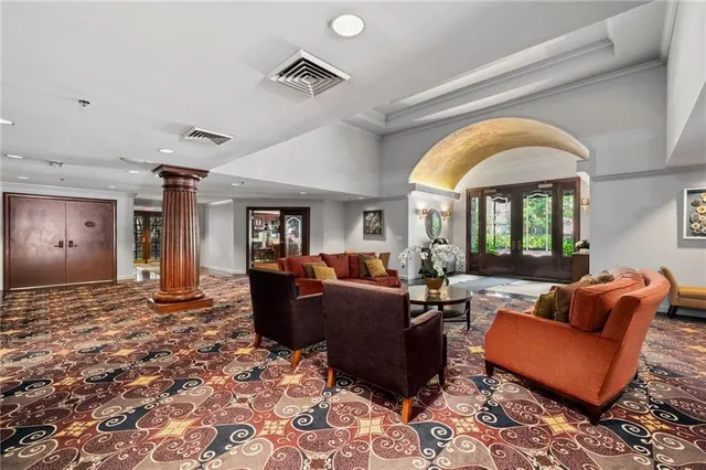 a living room with furniture fireplace and a large window