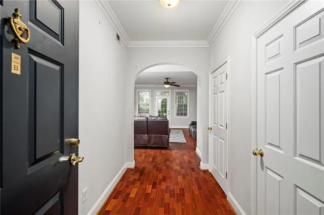 a view of a hallway with wooden floor and staircase