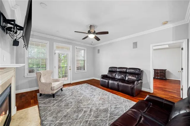 a living room with furniture fireplace and a large window