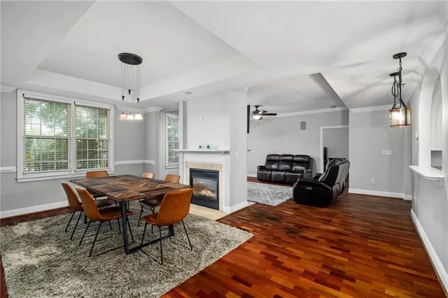 a view of a dining room with furniture and a chandelier