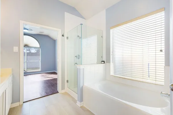 a bathroom with a bathtub and a shower