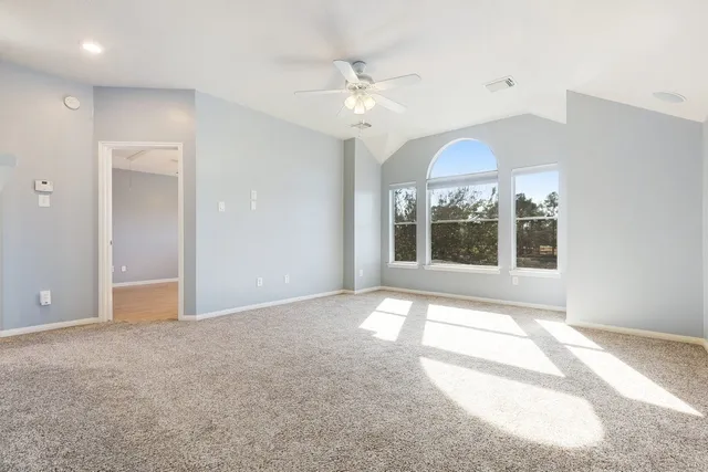 a view of a livingroom with a ceiling fan and window