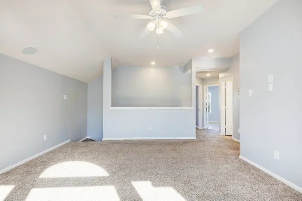 a view of a livingroom with a ceiling fan and window