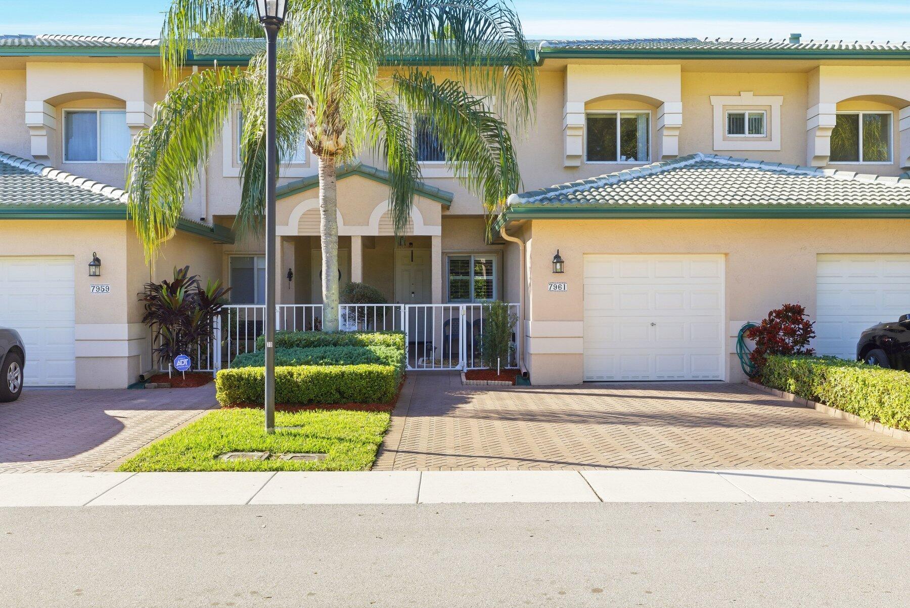 a front view of a house with a garden and plants