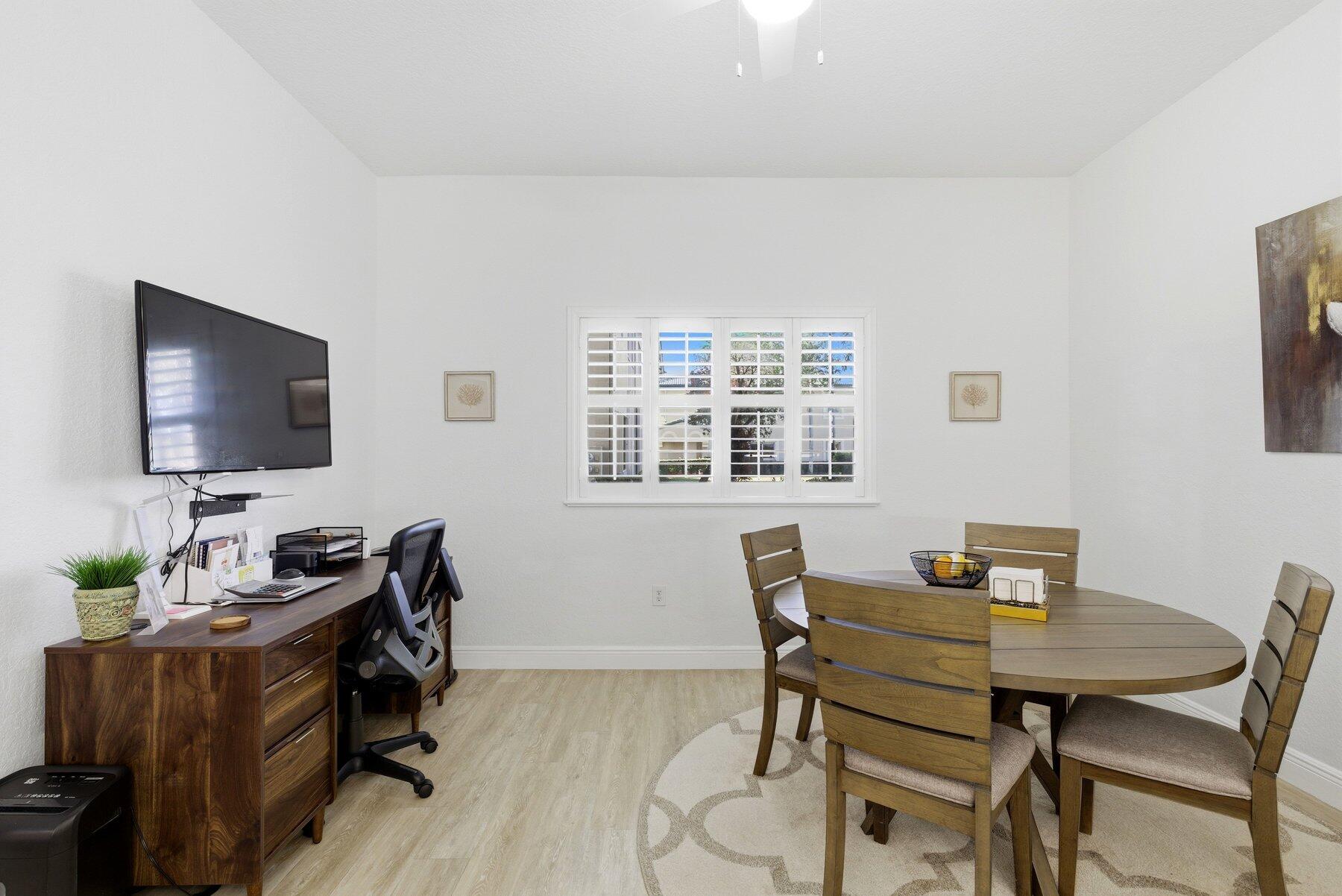 7961 Exeter Boulevard East, Unit 102 Tamarac, FL 33321 - Photo 12 of 46 a view of a workspace with furniture and a flat screen tv