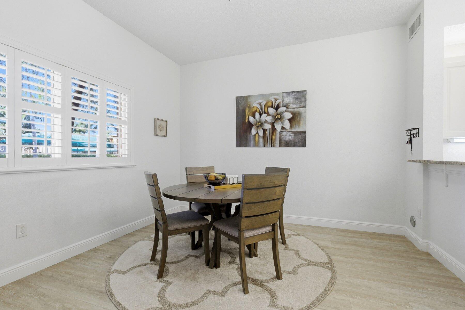 7961 Exeter Boulevard East, Unit 102 Tamarac, FL 33321 - Photo 13 of 46 a view of a dining room with furniture and a window