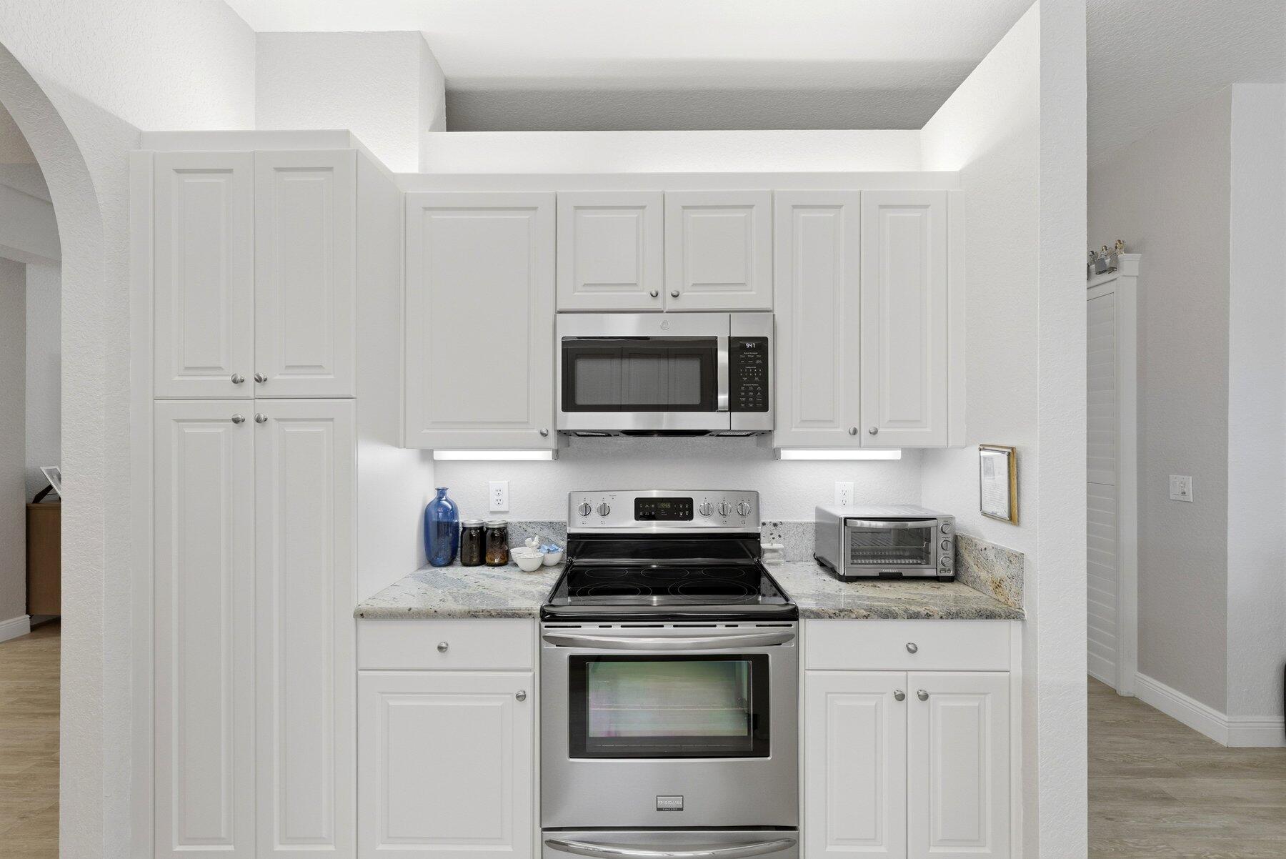 7961 Exeter Boulevard East, Unit 102 Tamarac, FL 33321 - Photo 17 of 46 a kitchen with appliances a sink and cabinets