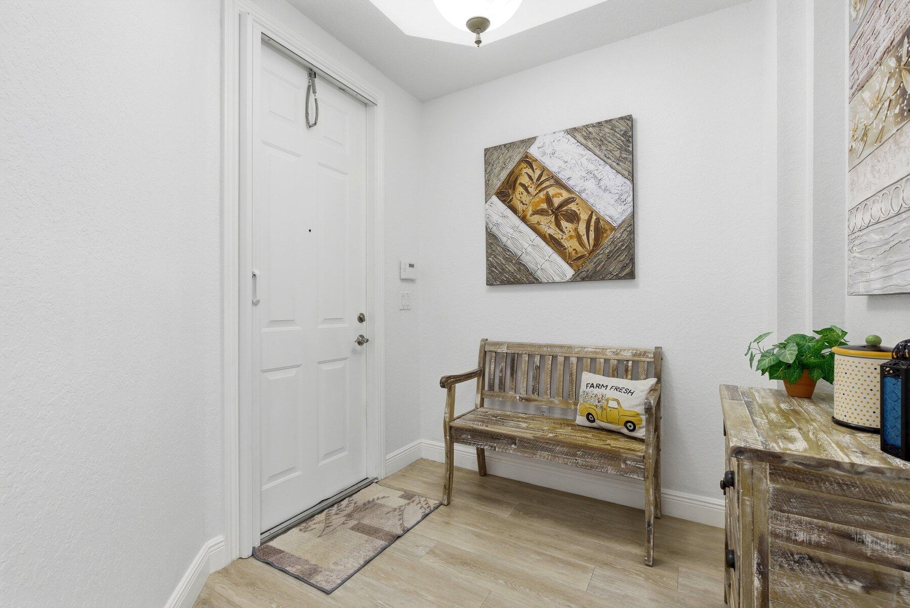 7961 Exeter Boulevard East, Unit 102 Tamarac, FL 33321 - Photo 2 of 46 a living room with furniture and a potted plant