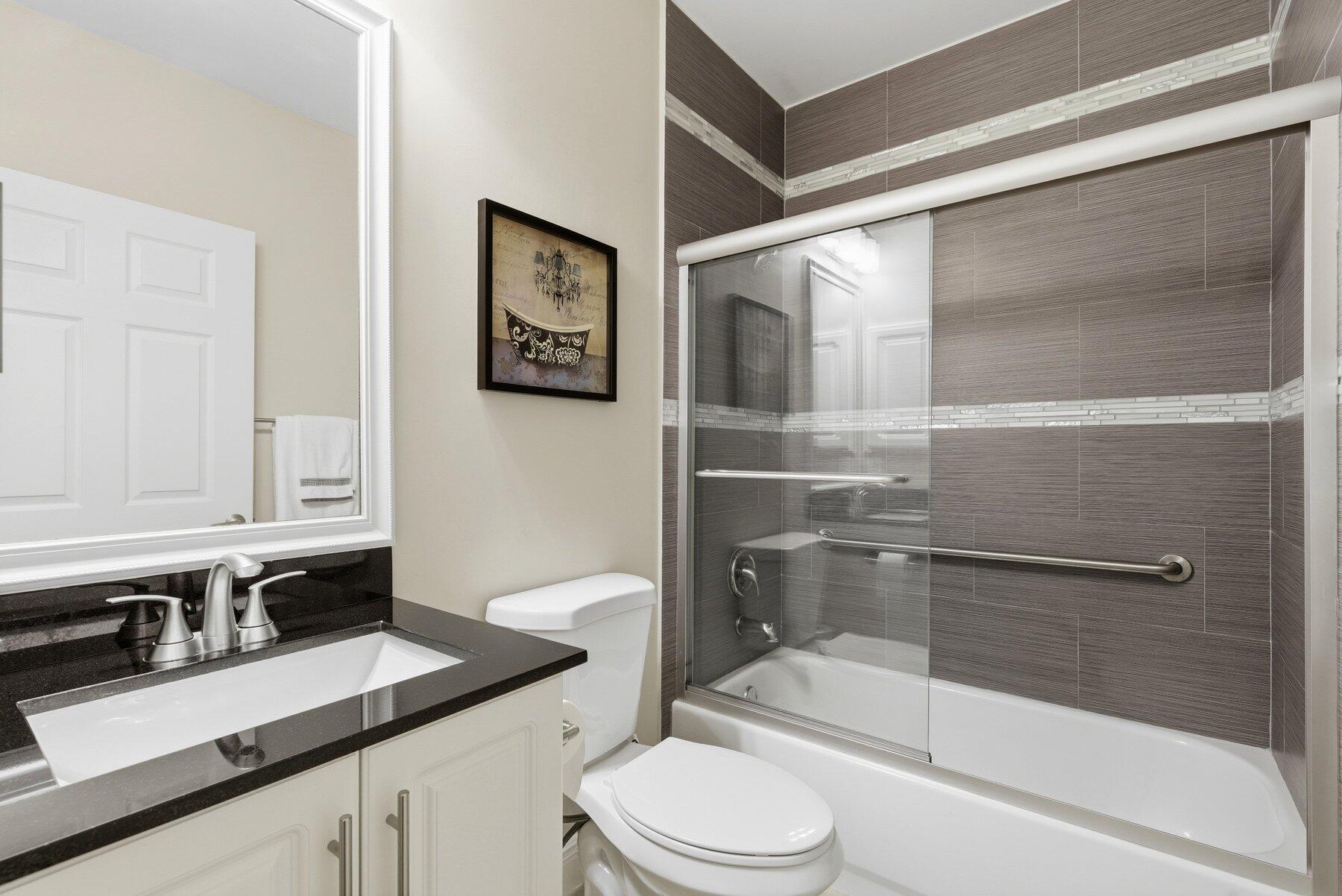 7961 Exeter Boulevard East, Unit 102 Tamarac, FL 33321 - Photo 28 of 46 a bathroom with a sink a toilet and shower