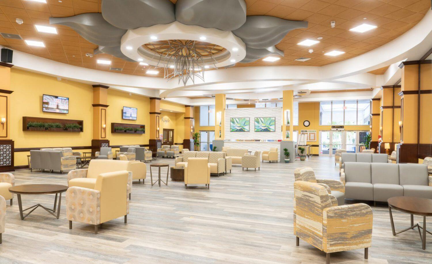 7961 Exeter Boulevard East, Unit 102 Tamarac, FL 33321 - Photo 38 of 46 a living room with lots of furniture and a chandelier