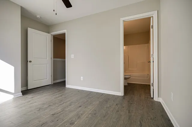 a bathroom with a granite countertop sink a toilet and shower