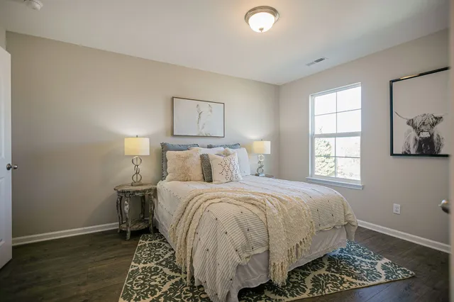 a bedroom with a bed and a mirror