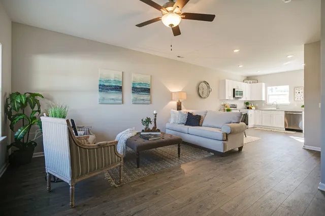 a living room with furniture and a wooden floor