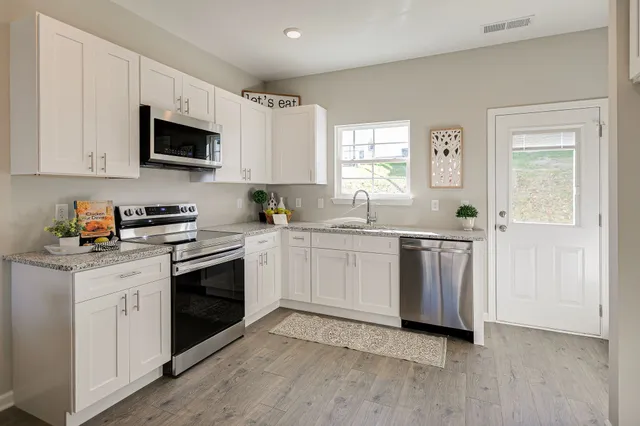 a kitchen with a sink cabinets and window