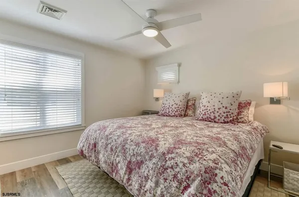 a bedroom with a large bed and a window