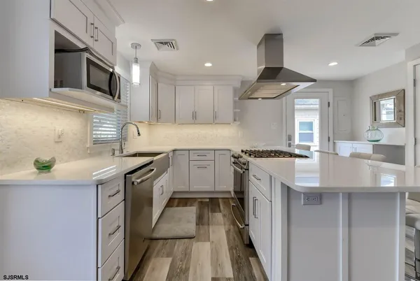 a kitchen with a sink stove and microwave