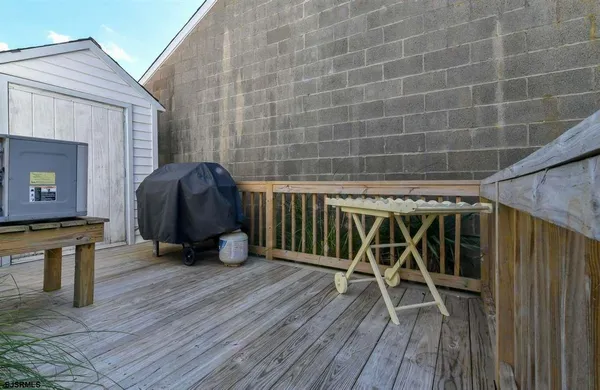 a view of a chairs and table on the wooden deck