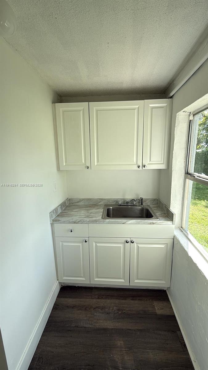 10680 Southwest 172nd Street, Unit 106271 Miami, FL 33157 - Photo 3 of 5 a kitchen with a sink and cabinets