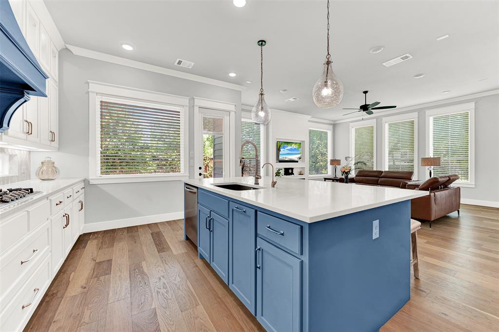 452 Jones Street Grapevine, TX 76051 - Photo 12 of 38 Prepping for meals is easy on the large island stainless steel dishwasher and sink.